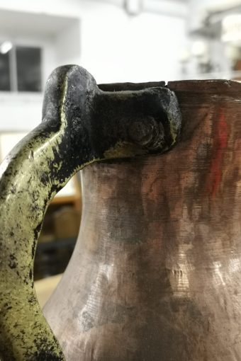 Antique copper jug with iron handle